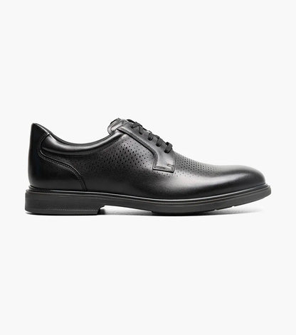 Side view of a black leather men’s lace-up dress shoe with perforated detailing and a low rubber sole.