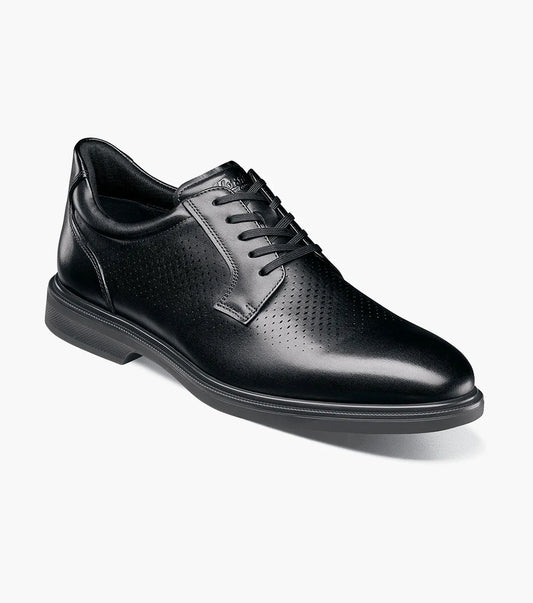Angled view of a black leather men’s lace-up dress shoe with perforated detailing and a cushioned rubber sole.