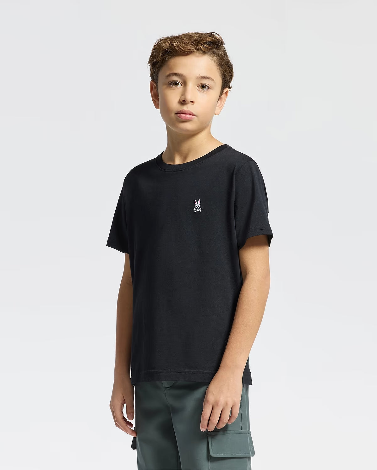 Side view of boy wearing Psycho Bunny Kids black crew-neck T-shirt