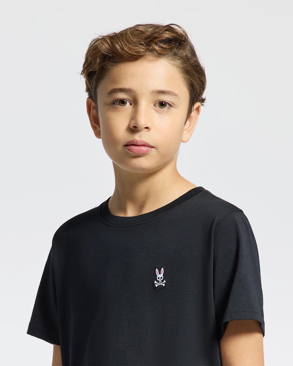 Boy modeling Psycho Bunny Kids Classic black short-sleeve T-shirt