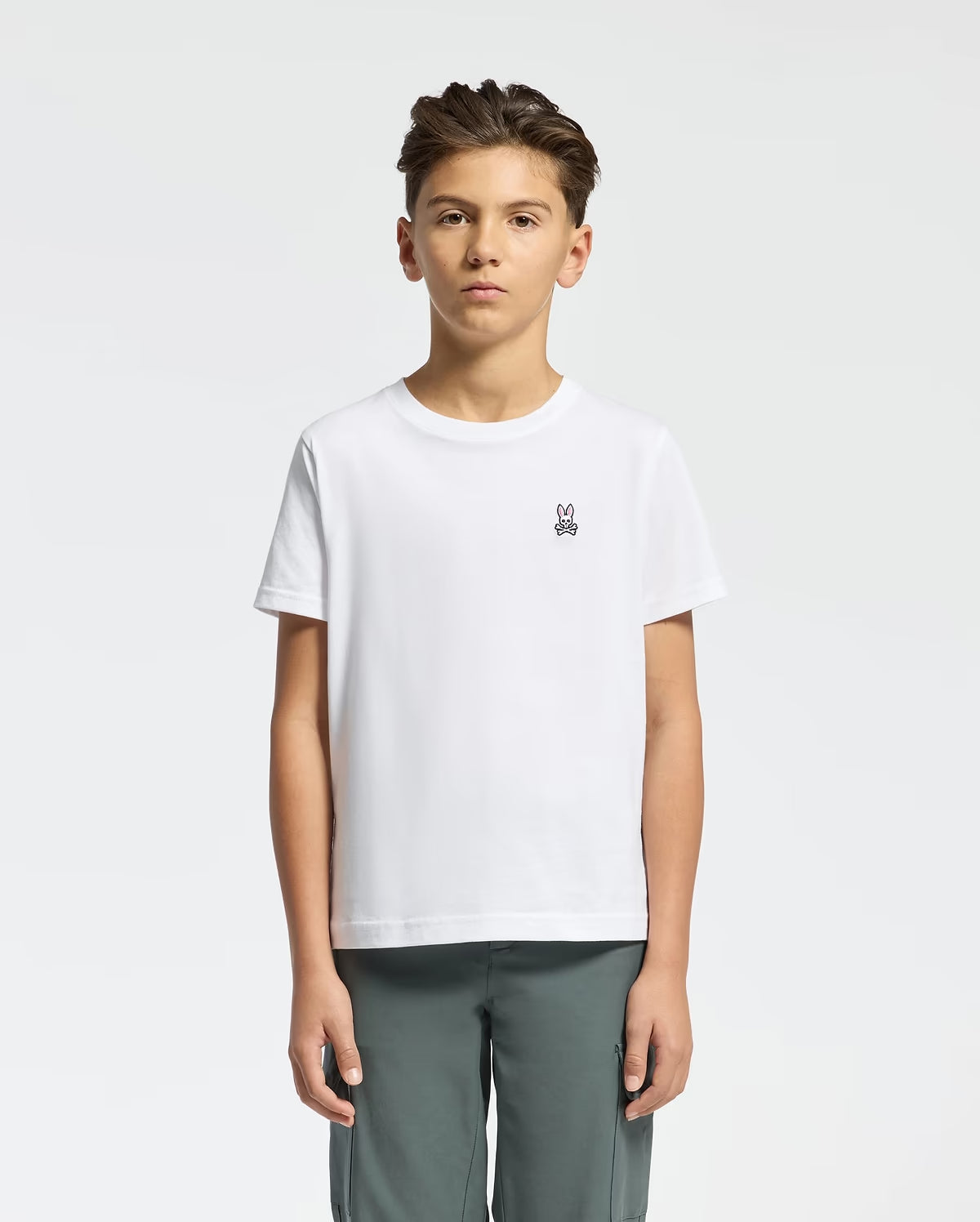 Boy wearing Psycho Bunny Kids Classic Crew Neck T-Shirt in 100 White front view