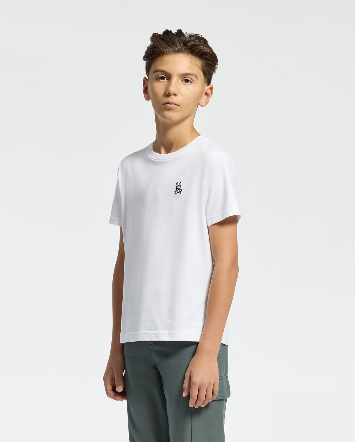Side view of boy wearing Psycho Bunny Kids white crew-neck T-shirt