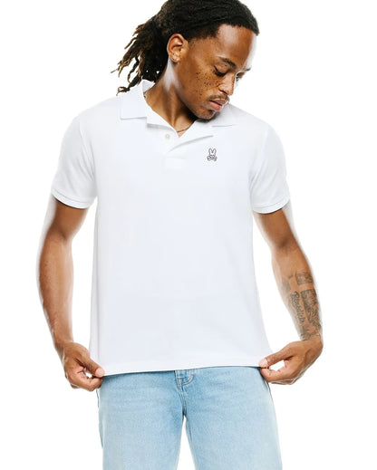 Man wearing a psycho bunny white polo front view