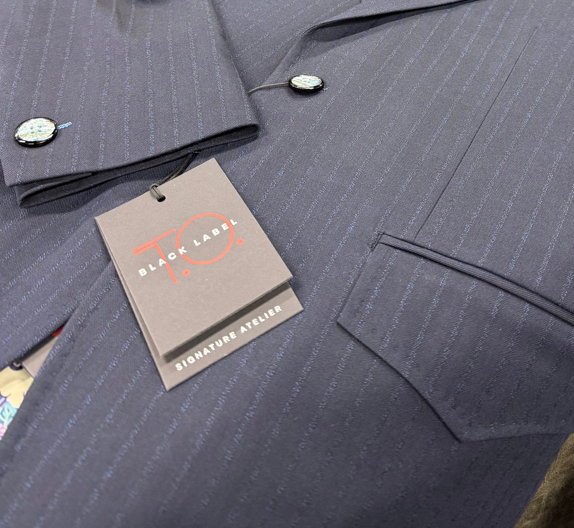 Close up navy pinstripe fabric T.O. Black Label 