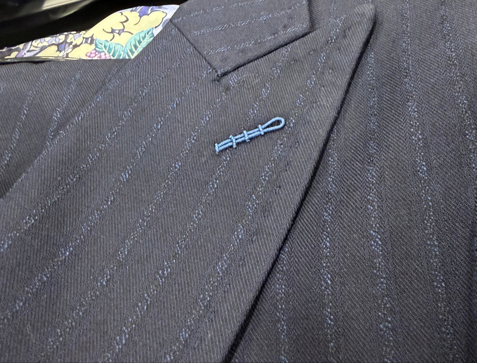 Close up navy pinstripe fabric T.O. Black Label boys suit pique stitching