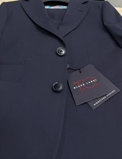 Navy coat with a tag on a white surface