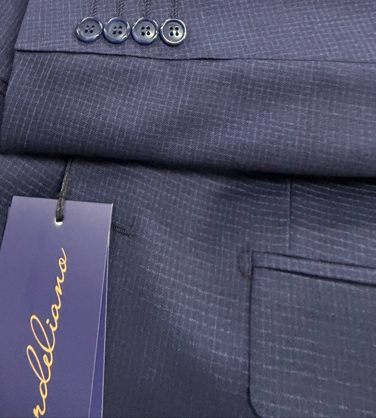 Dark navy suit jacket with a visible brand tag 