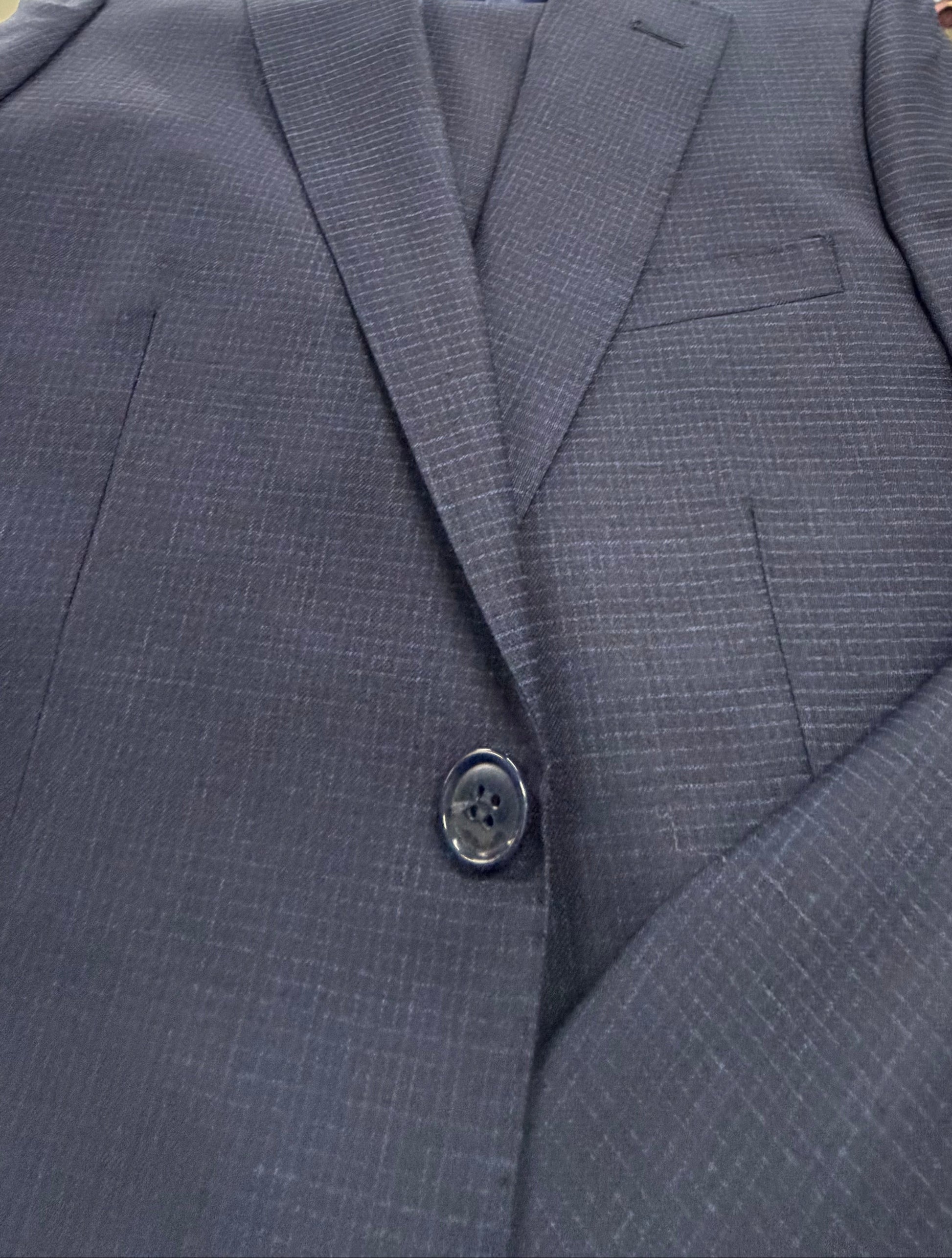 Close-up of a blue suit jacket with button