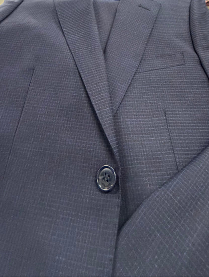 Close-up of a blue suit jacket with button