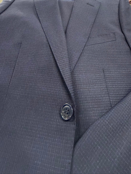 Close-up of a blue suit jacket with button